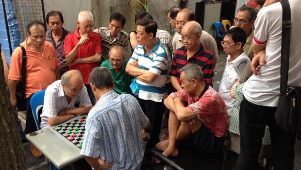 Elderly Chinese men playing draughts in Chinatown Singapore 2013 620x350.jpg